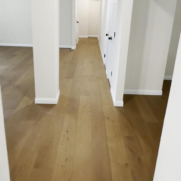 Engineered hardwood through a hallway with columns