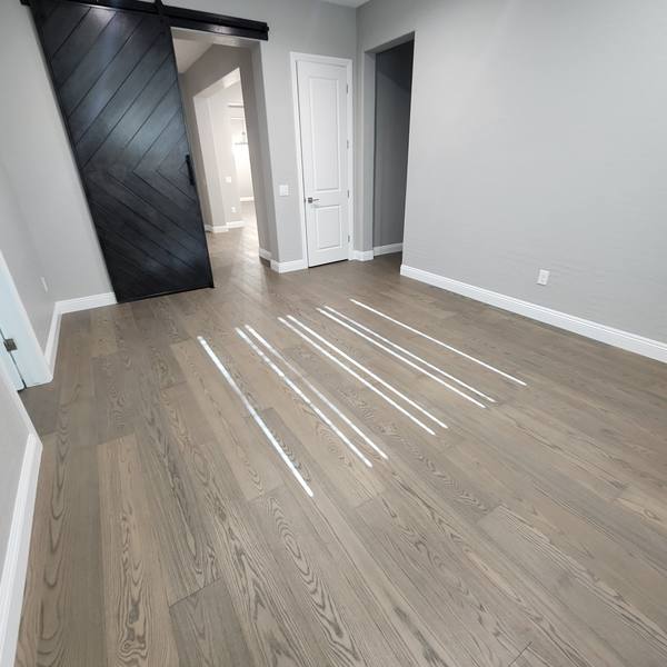 Engineered hardwood in a bedroom with a barn door