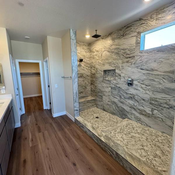 Primary bathroom with a walk-in tile shower