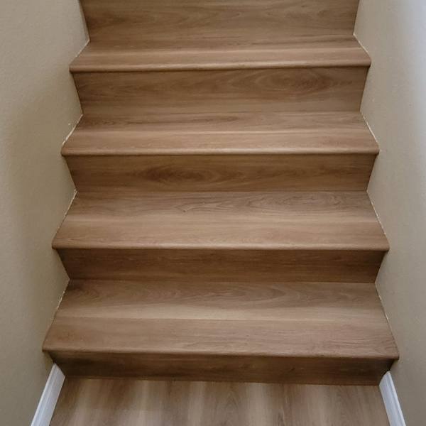 Stairs with light oak treads and risers, seen from the bottom