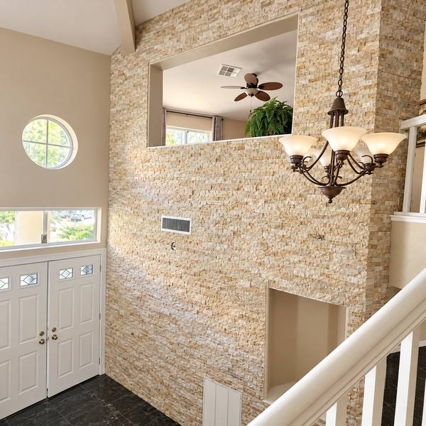 Two-story stacked-stone entry wall