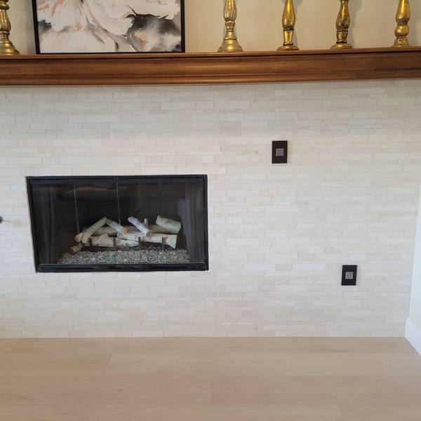 Fireplace wall finished in light stone
