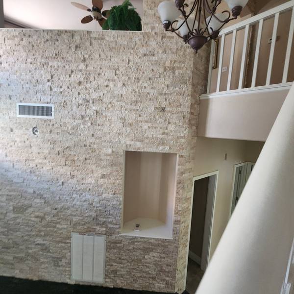 Stacked-stone entry wall seen from the stairs