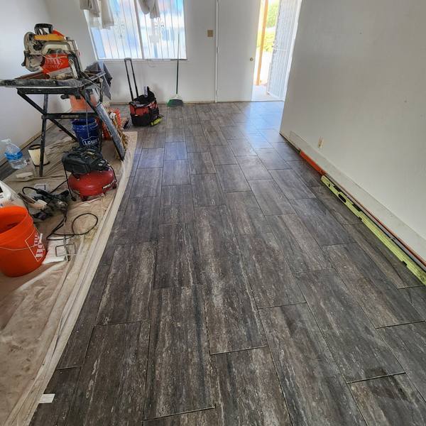 Dark veined tile running to the front door
