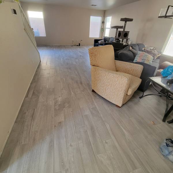 Gray wood-look plank tile down a long living room