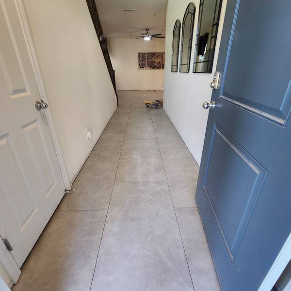 Tile floor down a hallway to the front door