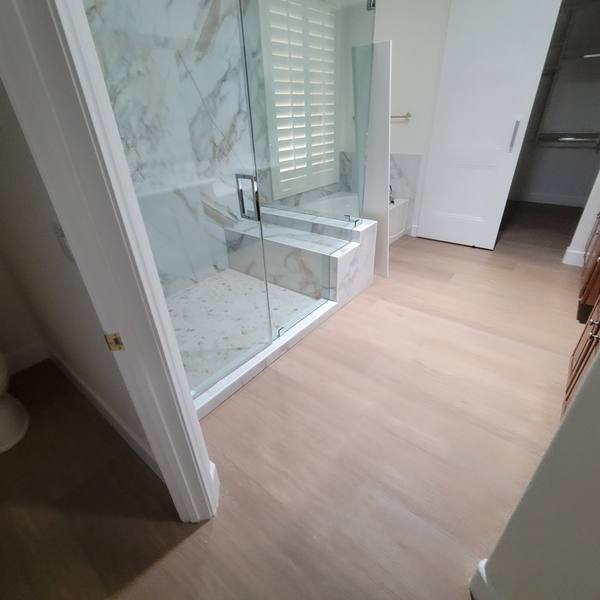 12x72 wood-look tile in a primary bathroom with a walk-in shower