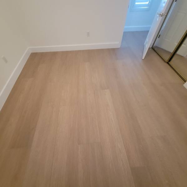 12x72 wood-look tile in a bedroom with a mirrored closet