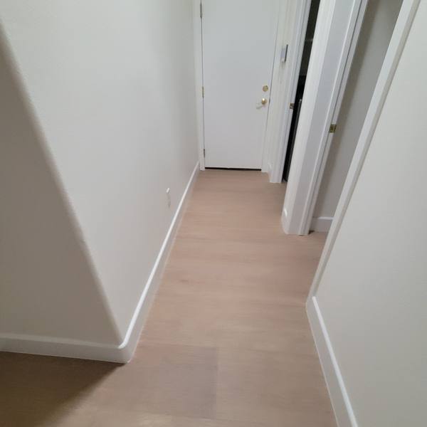 12x72 wood-look tile in a hallway leading to a door