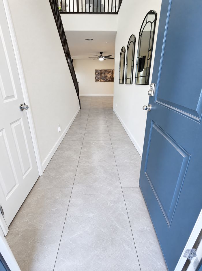 Same hallway finished in gray marble-look porcelain tile