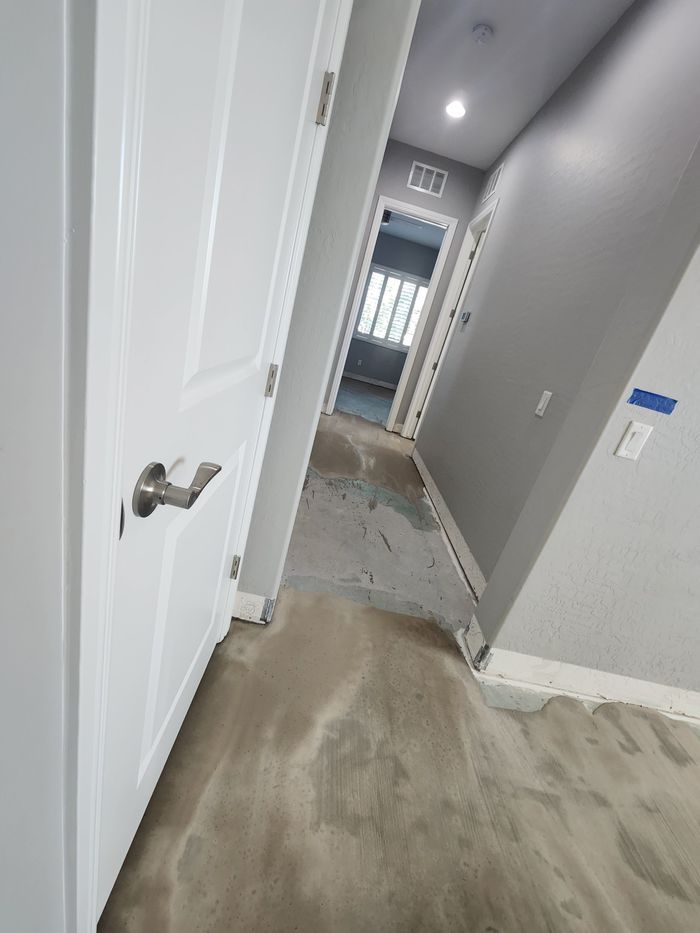 Hallway on bare slab, patched and prepped before engineered hardwood