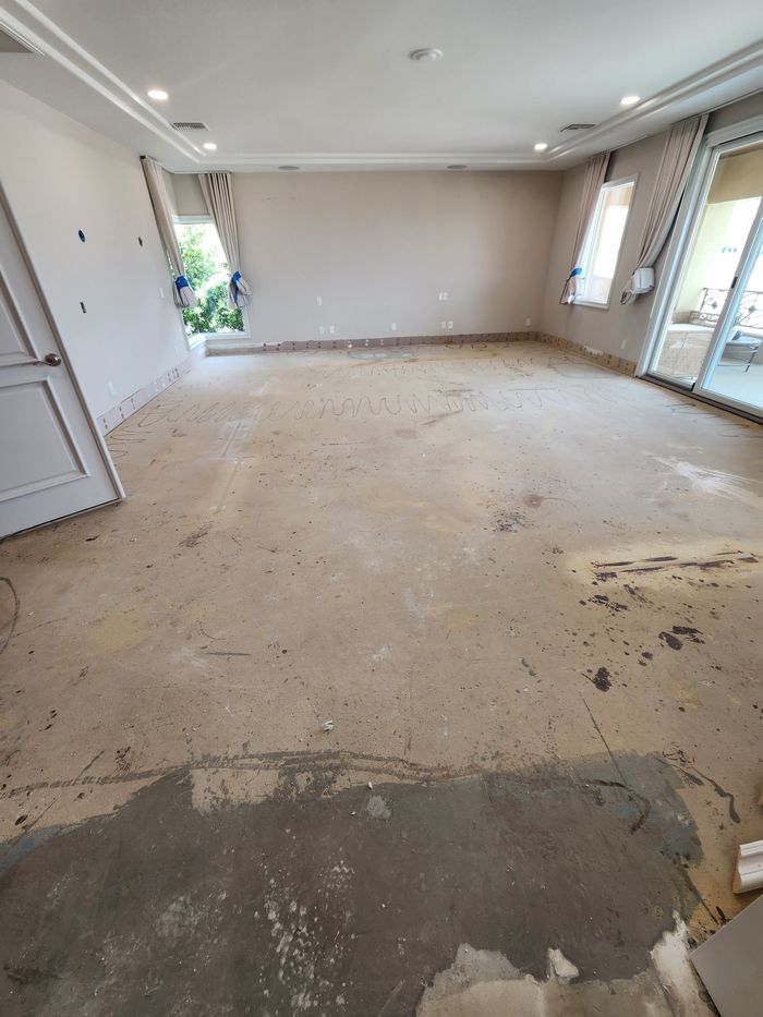 Upstairs primary bedroom on bare floor after the old flooring came out