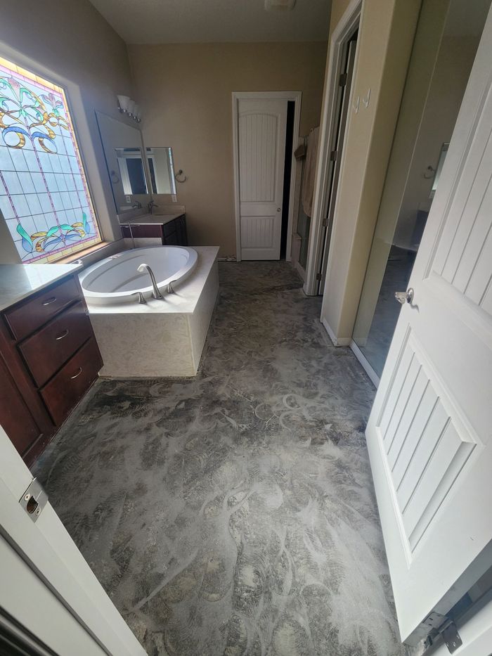 Primary bath on bare slab after the old tile came out