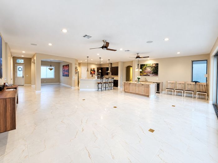 Finished white marble-look tile across the great room and kitchen