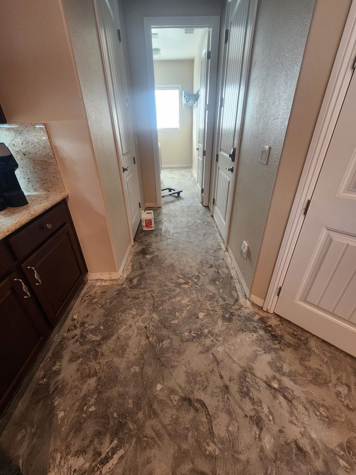 Same hallway with the old tile out and the slab scraped